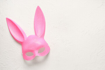 Pink bunny mask on white grunge background