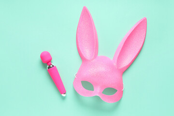 Pink bunny mask with vibrator on turquoise background