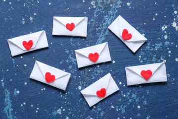 Envelopes with hearts on blue grunge background. Valentine's Day celebration