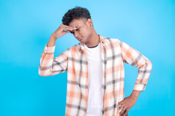 Dizzy Young Asian Man Feeling Headache Isolated on Blue Background