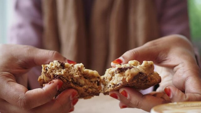  woman hand breaking sweet cookies 