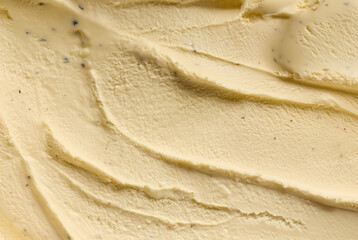 Close-up of creamy vanilla ice cream texture with smooth swirls, showcasing rich and indulgent dessert