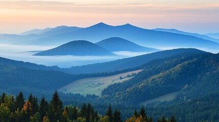 Obraz premium Misty morning view of mountain ranges with blue skies.