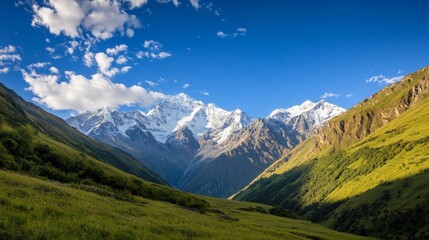 Obraz premium photo of the majestic beauty of a towering mountain range, with rugged peaks covered in snow, lush green valleys below, and a clear blue sky, creating a breathtaking natural landscape