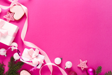 Gift boxes with Christmas decor on pink background