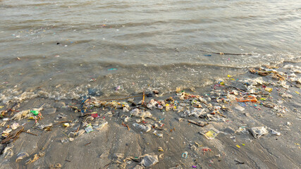 Trash, plastic cups and plastic bags at the beach. environmental problem concept and healing the world	