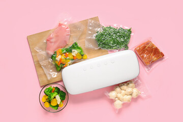 Vacuum sealer machine for food with meat and vegetables in packs on pink background