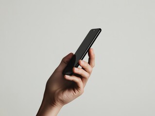 2408 125.A clear close-up of a hand holding a smartphone in front of a plain white background. The hand is positioned naturally, and the phone is in sharp focus, making the image ideal for
