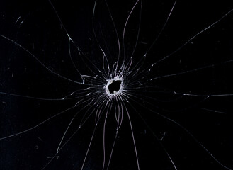 Obraz premium Broken glass bullet holes isolation on black background,Cracked glass