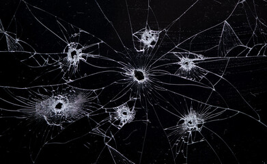 Broken glass bullet holes isolation on black background,Cracked glass