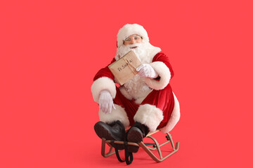 Santa Claus with letters on sledge against red background