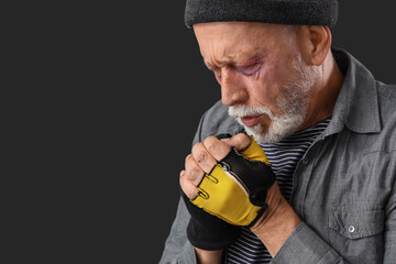 Frozen homeless man on dark background, closeup