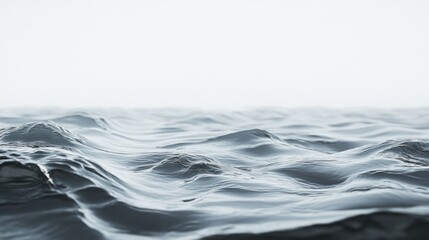 A serene view of gentle ocean waves under a soft, light sky.
