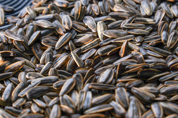 Close-up view of black sunflower seeds after roasting.