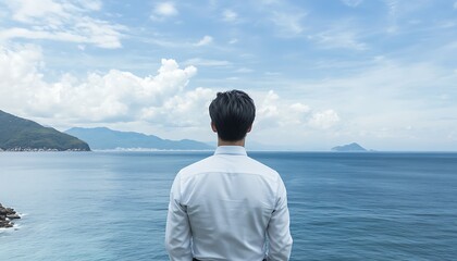 Fototapeta premium Man Gazing at the Expansive Ocean