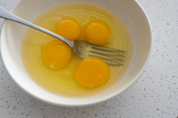 Egg yolks in white bowl ready to mix