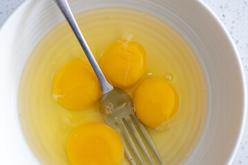 Egg yolks in white bowl ready to mix