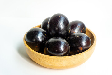 Grilled salted eggs on wooden bowl. Salted eggs are usually made from duck eggs fermented with ash and salt.
