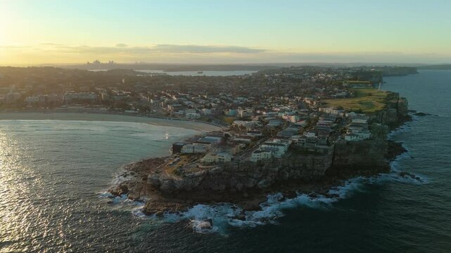 Aerial video of Bondi Beach at sunset with view of Sydney CBD skyline