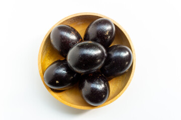 Grilled salted eggs on wooden bowl. Salted eggs are usually made from duck eggs fermented with ash and salt.