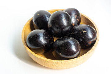 Grilled salted eggs on wooden bowl. Salted eggs are usually made from duck eggs fermented with ash and salt.