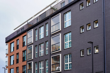 Close up of new modern red and brown brick building during the day with no people. Many windows. Tallinn, Estonia, Europe September 2024