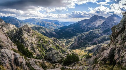 Fototapeta premium Breathtaking mountain valley view with rocky formations and lush greenery, perfect for nature enthusiasts and adventure seekers.