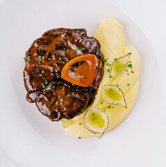 Gourmet steak with mashed potatoes on white plate