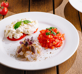 Gourmet tomato and cheese appetizers on elegant table setting