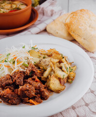 Delicious beef stew served with roasted potatoes and fresh coleslaw salad