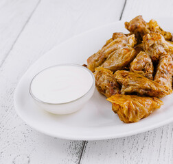 Cabbage rolls stuffed with minced meat and rice lying on white plate