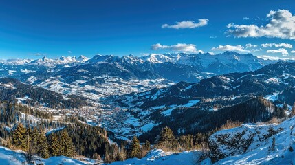 Stunning panoramic winter landscape showcasing snow-covered mountains and a clear blue sky, ideal for travel and nature themes.