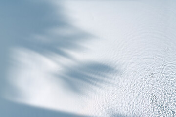 Clear turquoise pool water glistens under sunlight with gentle ripples