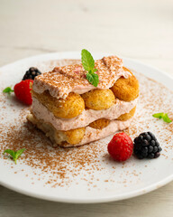 Italian tiramisu with red berry cream. Top view table with  decorations.