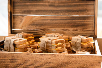 delicious sandwiches with cheese on a wooden board