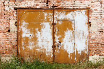 The door is rusted and has white paint on it