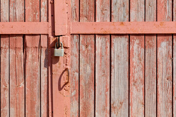 A rusty lock on a wooden door
