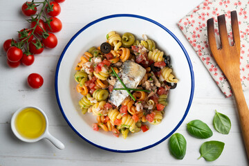 Italian pasta with sardines and black olives. Top view table with  decorations.