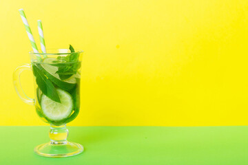 Mojito summer refreshing cocktail with ice and mint. mojito cocktail with lime, lemon and mint in a tall glass with a stick