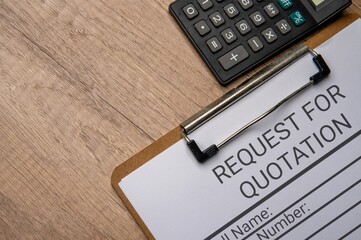 A clipboard with a paper titled “REQUEST FOR QUOTATION” and a black calculator. Procurement or...