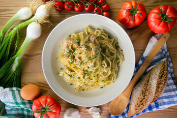 Fresh Italian pasta with salmon and cream. Top view table with decorations.
