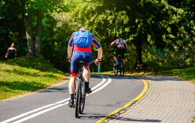 Naklejka premium Cyclist ride on the bike path in the city Park 