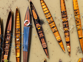 The kayaks are tied together side by side on the water.