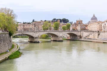 Obraz premium Rome, Italy - April 11, 2024: Rome, Italy - April 11, 2024: Rooftops and houses of the city of Rome, seen from the viewpoint of the Castel Santo Angelo in Rome, Italy