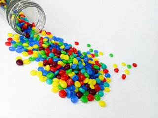 colorful masterbatch raw material granules,hot cut type colorful polymer granules,out of bottle,isolated on white background,for plastic industry profile product catalog design