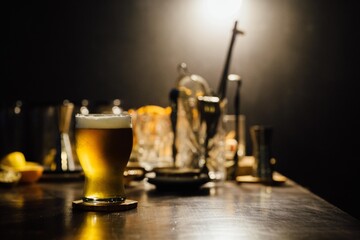 Glass full of beer on a speakeasy bar