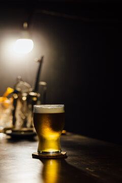 Glass full of beer on a speakeasy bar