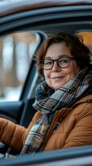 A woman in a brown coat and a plaid scarf smiles from the driver's seat of a car. AI.
