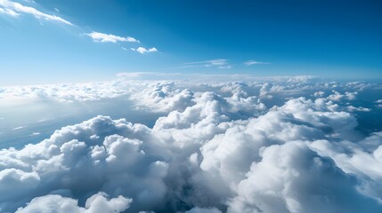 Fototapeta premium Aerial View of Soft White Fluffy Clouds Floating Gracefully Across a Bright Blue Sky Landscape
