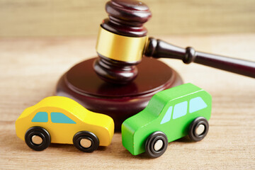 Car accident lawsuit and insurance, Judge hammer with car model.